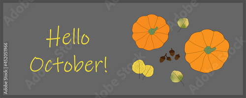 Bright colored autumn leaves and pumpkins on grey background with Hello October message. Top view. Fall, seasonal, October.