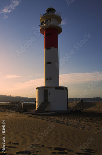 Sunset on a beautiful beach with a lighthouse