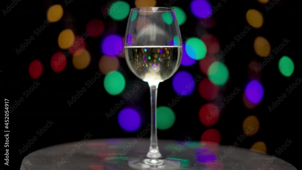White wine in glass with blurred lights White wine in glass with blurred lights