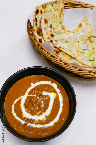 indian lentil curry known as dal makhani with tandoori naan bread photo