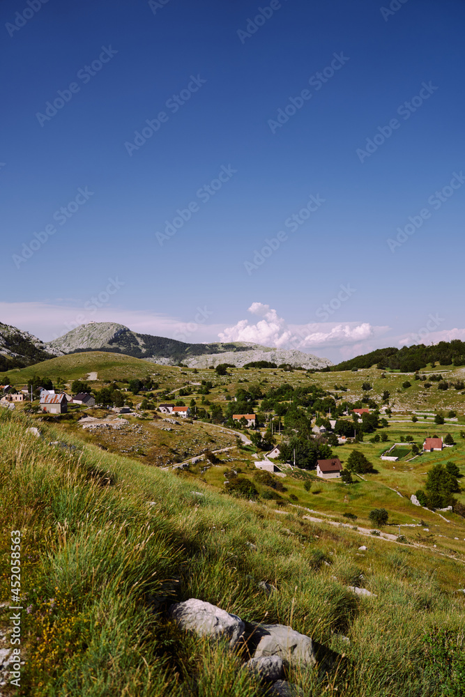 View of the village in the mountains against the backdrop of greenery