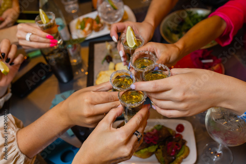 Clinking glasses with alcohol and toasting, party. photo