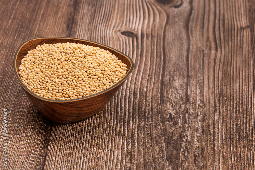 Organic pearl millet seeds in the bowl - Healthy food Organic pearl millet seeds in the bowl - Healthy food