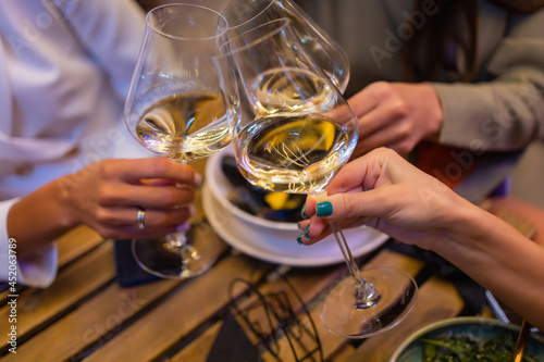 Clinking glasses with alcohol and toasting, party.