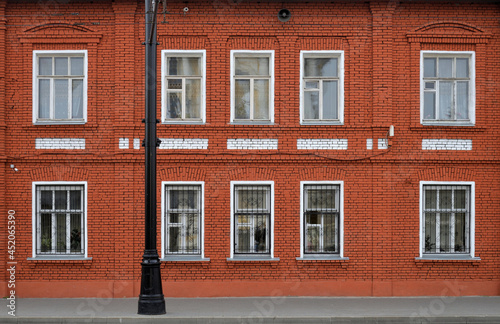Façade of old red brick house © Alexey Antipov