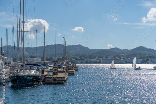 Moored nautical vessels at sea port San Antonio de Portmany, Balearic Islands, Ibiza, Spain. Sunny spring day. photo