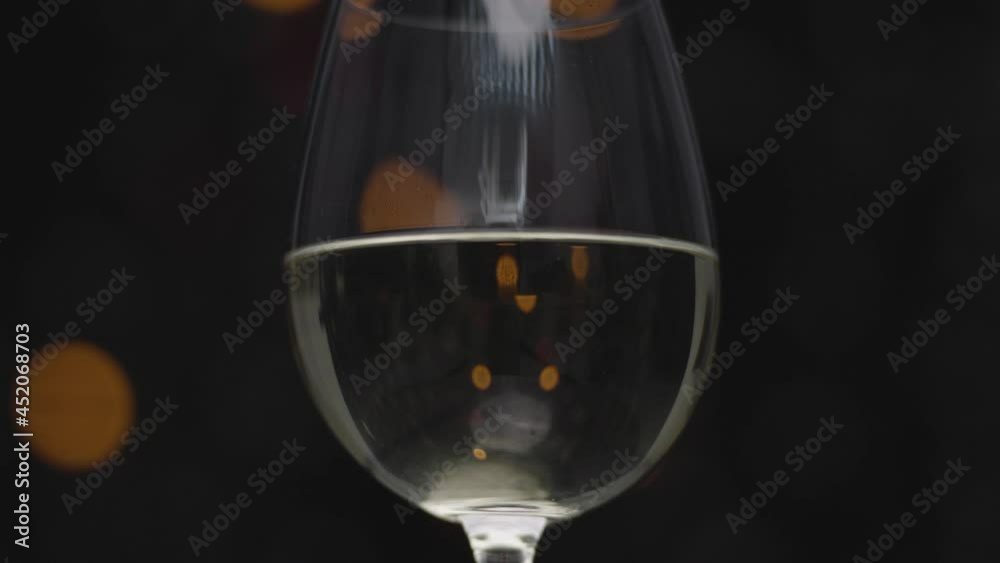 White wine in glass with blurred lights White wine in glass with blurred lights