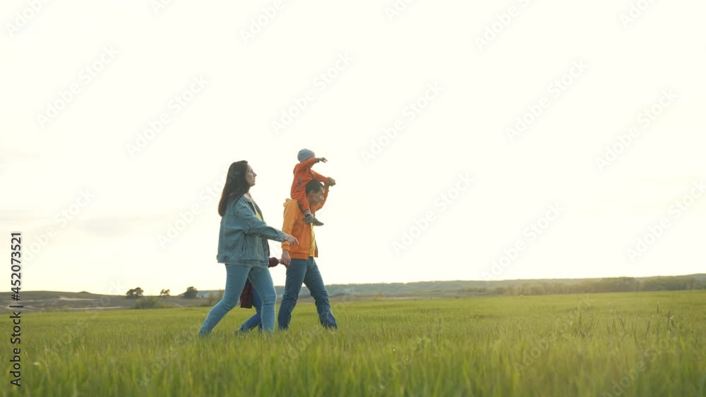 people in the park. happy family a walk at sunset. mom life dad and daughter walk holding hands in the park. happy family kid dream concept. parents and baby fun walking forest park people in the park. happy family a walk at sunset. mom life dad and daughter walk holding hands in the park. happy family kid dream concept. parents and baby fun walking forest park