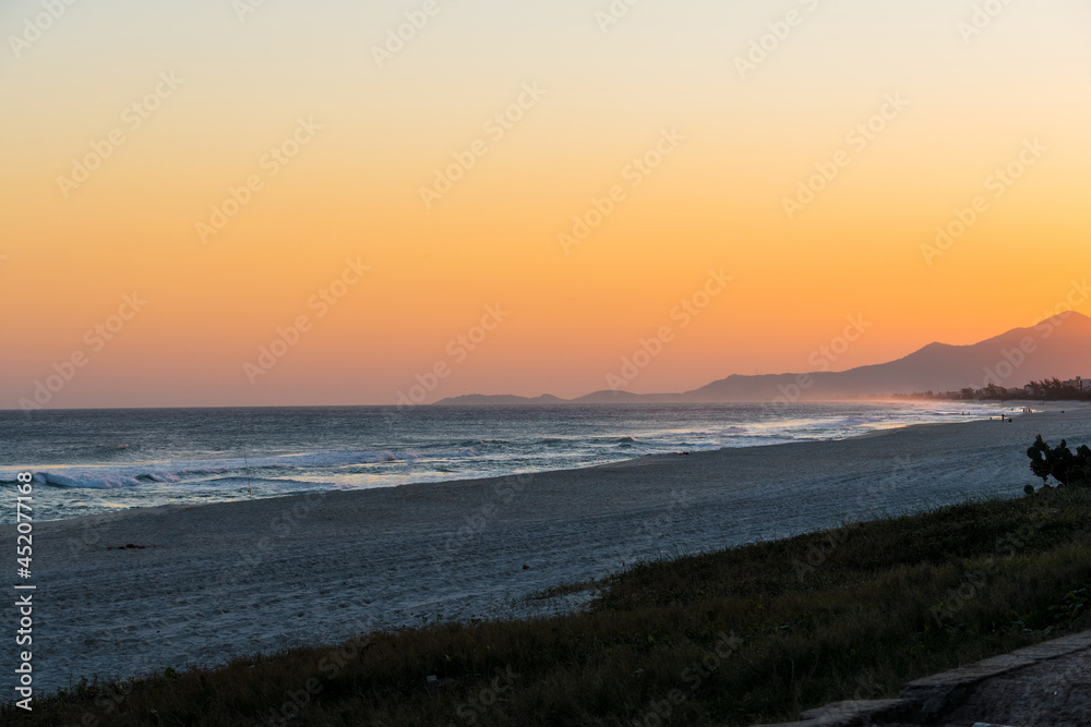 Sunset at Saquarema beach in Rio de Janeiro, Brazil. Famous for waves and surfing. Church on top of the hill.