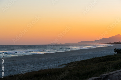 Sunset at Saquarema beach in Rio de Janeiro, Brazil. Famous for waves and surfing. Church on top of the hill. photo