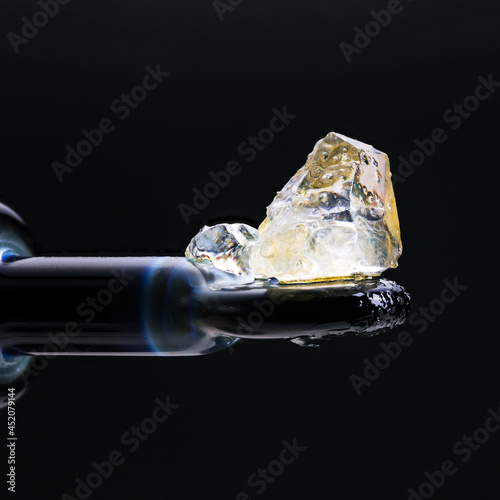 THC Cannabis Diamonds laying on a glass dab tool. 