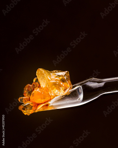 Gold and Amber colored Cannabis Diamonds on a Glass Dab Tool