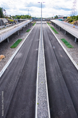Fototapeta Naklejka Na Ścianę i Meble -  Stockholm, Sweden  Empty traffic lanes leading into the new 21 kilometer-long Stockholm Bypass tunnel to be opened in 2025.