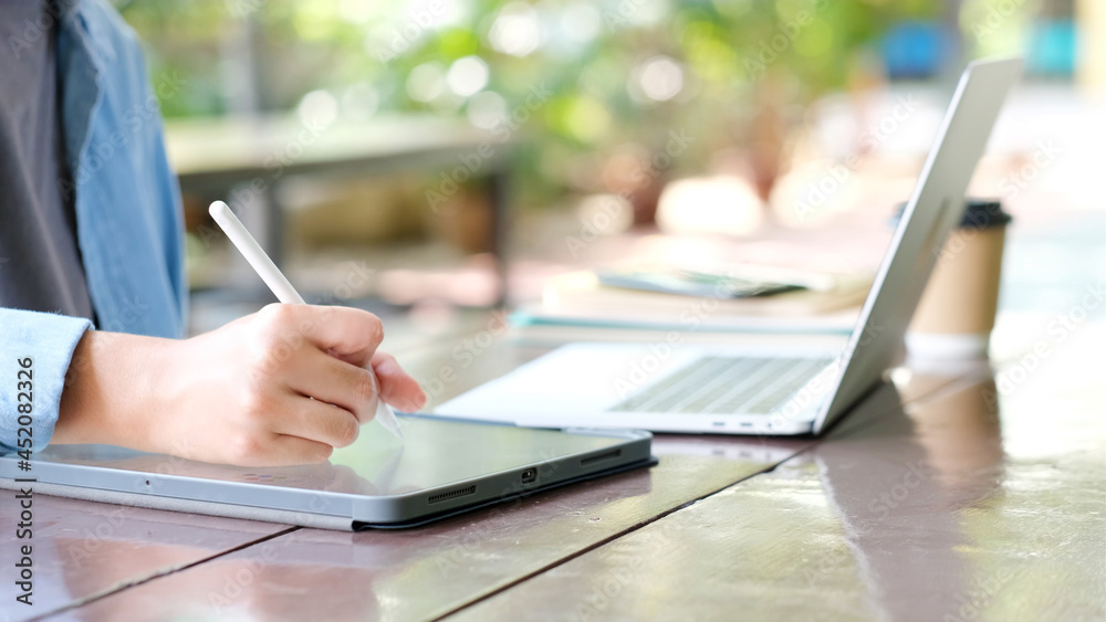 Close up of man hand using digital tablet for working at home, online study, telecommunication Close up of man hand using digital tablet for working at home, online study, telecommunication