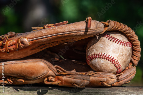 Baseball in old leather baseball glove