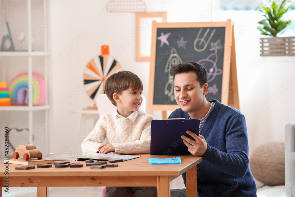 Speech therapist working with little boy in office Speech therapist working with little boy in office