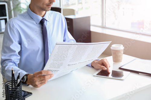 Young businessman reading n...