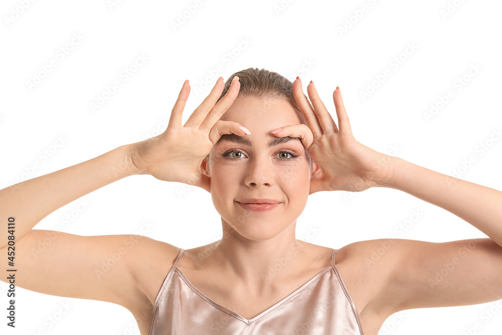 Beautiful young woman doing facial yoga on white background Beautiful young woman doing facial yoga on white background