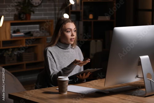Young woman video chatting ...