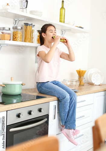 Little girl eating tasty sa...