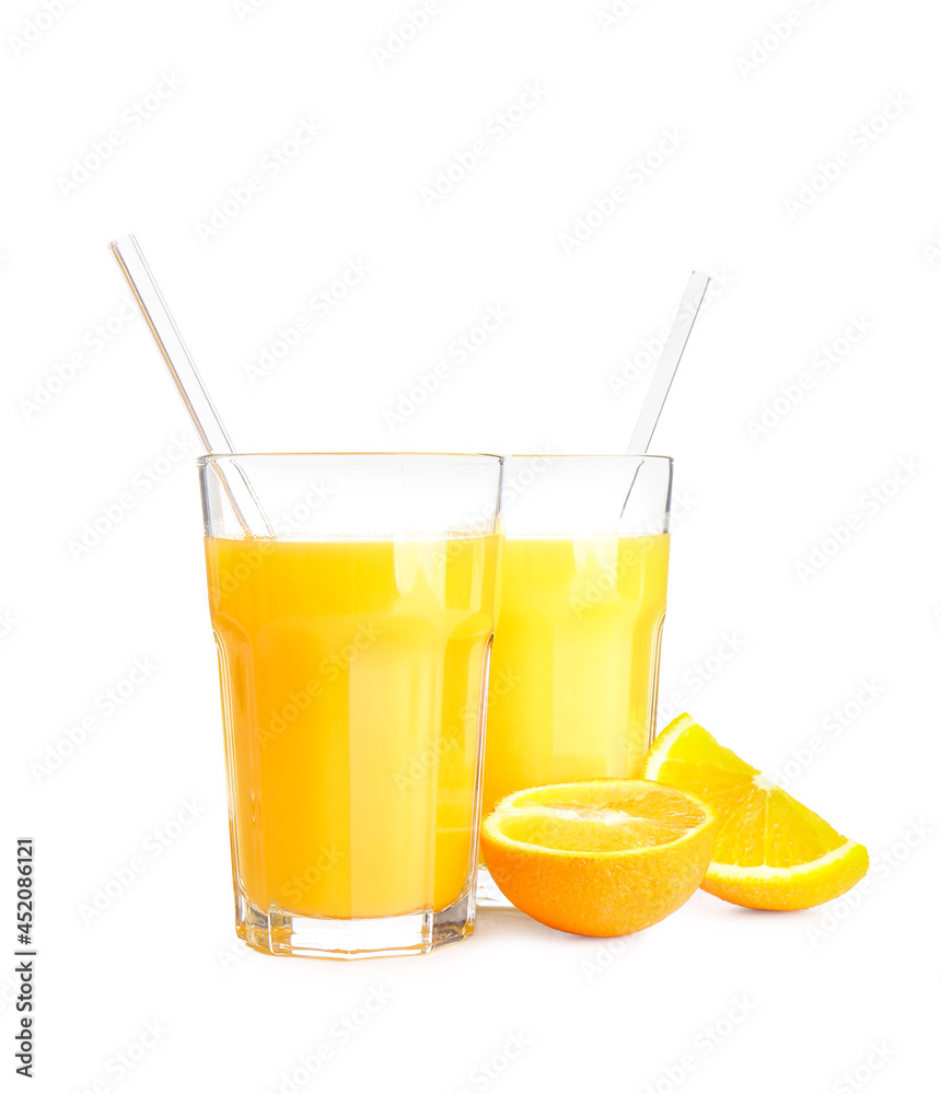 Glasses of tasty orange juice on white background
