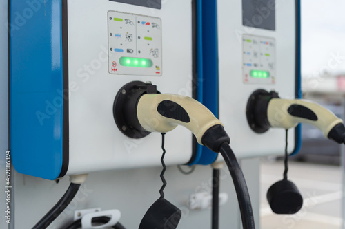 Cable from EV car charger or electric vehicle station. Cable connected at gas station, power supply battery charging an alternative eco environment future technology energy innovation