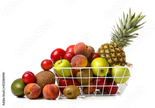 Basket with fresh fruits on white background