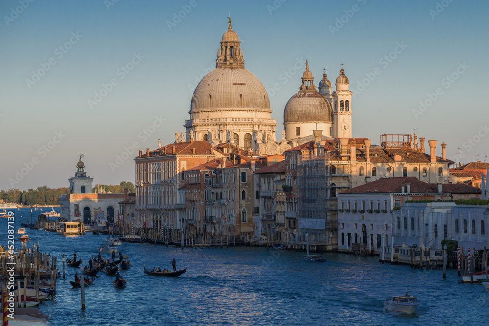 Dome of the Cathedral of Santa Maria della Salute in the cityscape on a sunny September evening. Venice. Italy