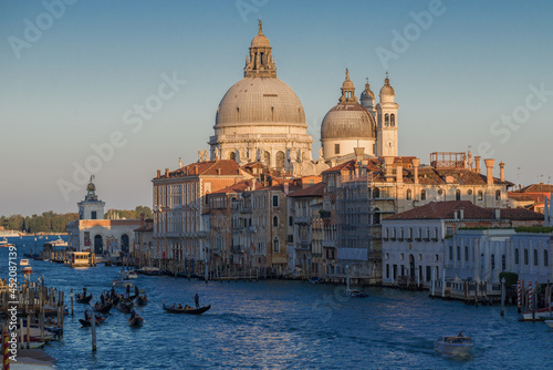Dome of the Cathedral of Santa Maria della Salute in the cityscape on a sunny September evening. Venice. Italy