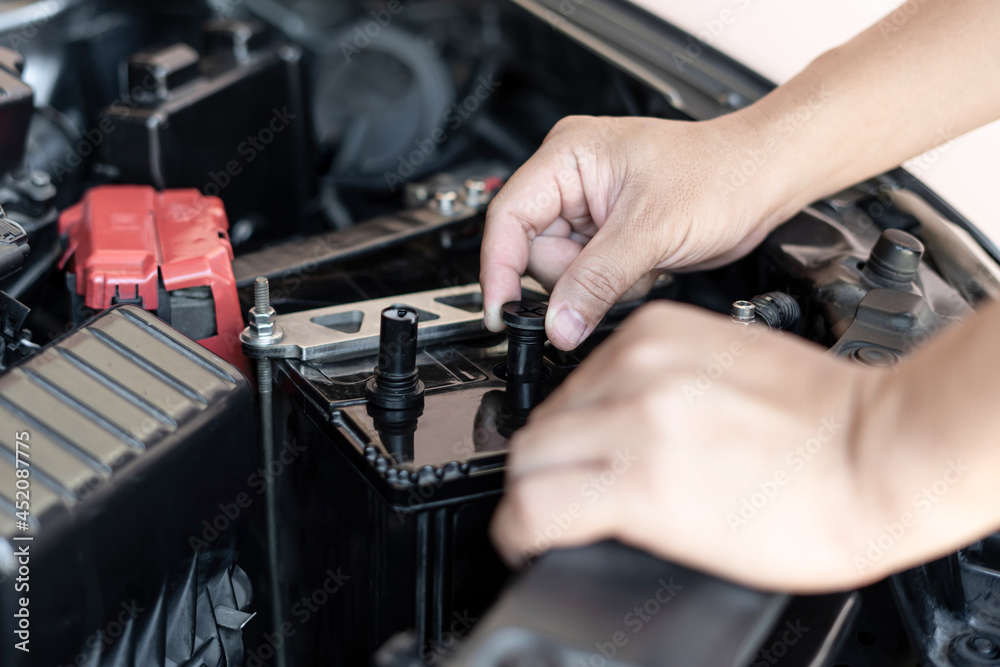 A man open cap of add battery for add distilled : maintenance and inspections for extended service life battery of car