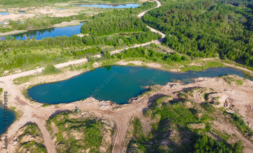 Flooded sand quarry near Sychevo area. Lush green summer landscape for outdoors vacation, hiking, camping or tourism. Volokolamsk district of Moscow region. Russia
