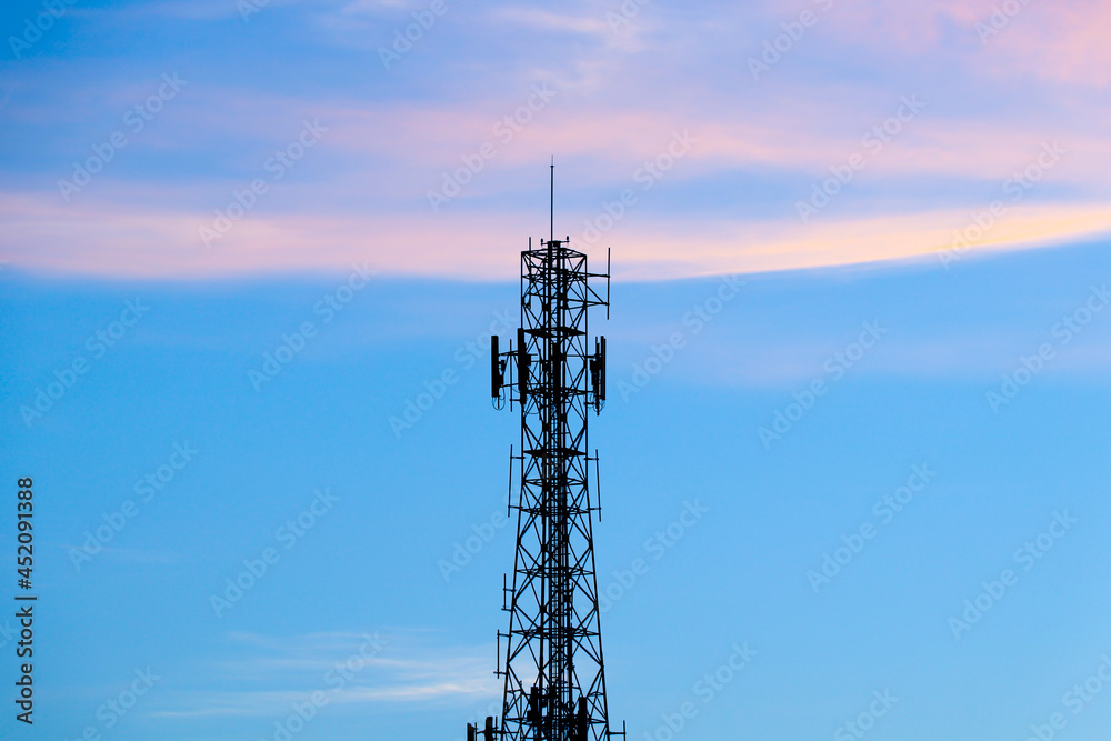 Cell sites or cell phone tower on central of photo with cloud on the sky in the evening