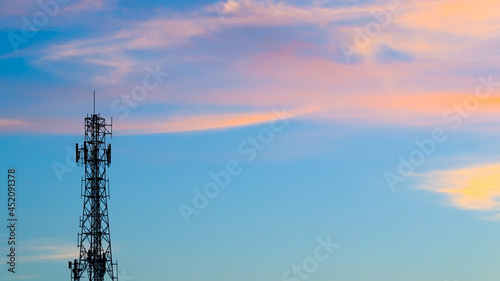 Cell sites or cell phone tower on central of photo with cloud on the sky in the evening