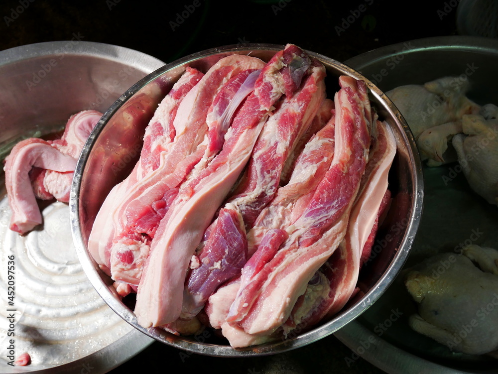 Pile of fresh streaky pork in the stainless bowl. Preparation food concept. 