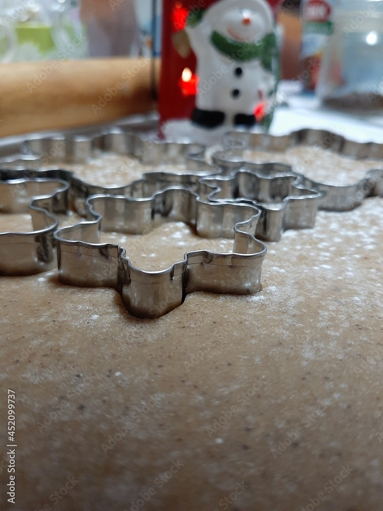 Dough for gingerbread. Rolled dough. Cookie cutters. Snowflake shape. New Year's Eve is coming. Dough for gingerbread. Rolled dough. Cookie cutters. Snowflake shape. New Year's Eve is coming.