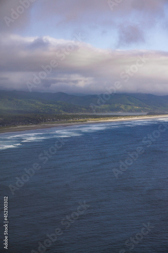 beach ocean view with trees and sand summer clouds blue 