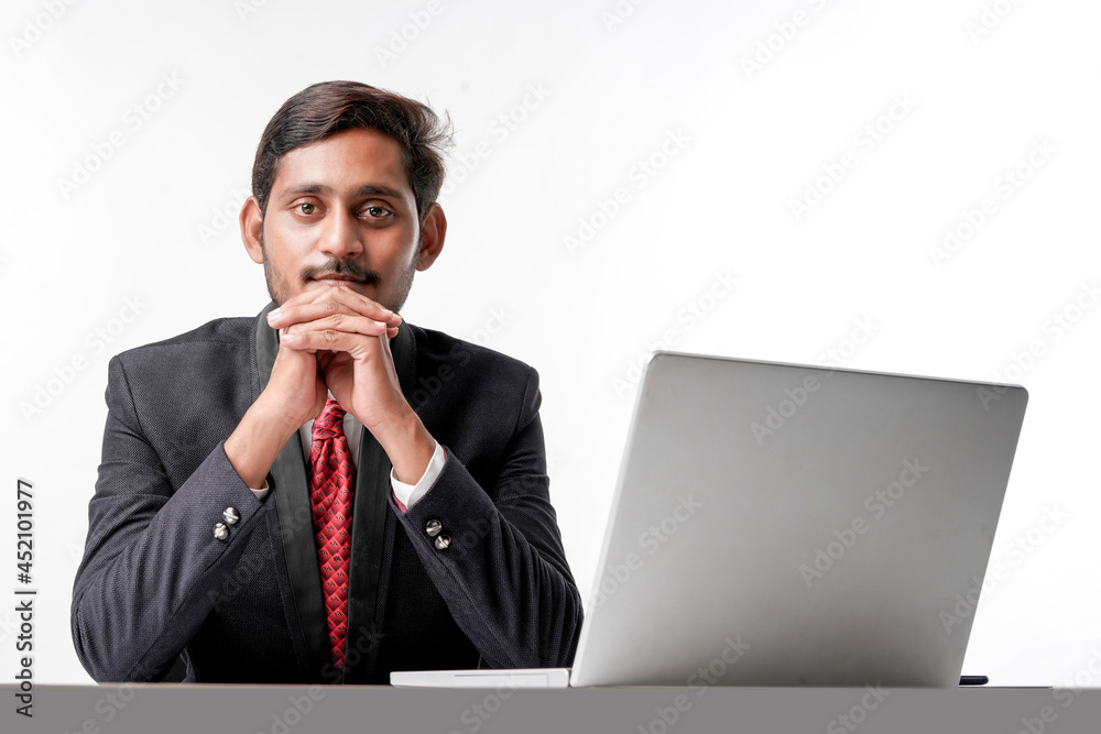 Young indian man in suit and working on laptop at office Young indian man in suit and working on laptop at office