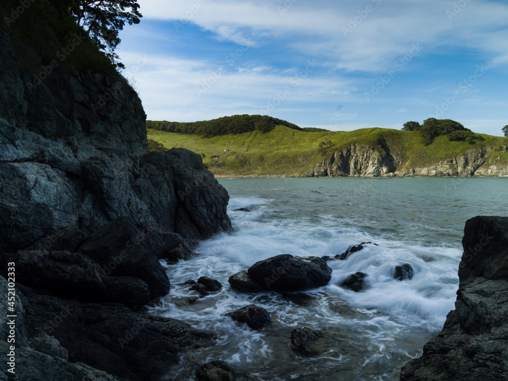 Fototapeta premium Tide wave on rocky shore.