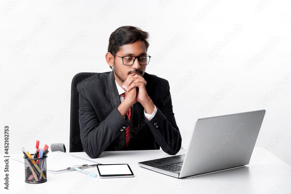 Young indian man in suit and working on laptop at office Young indian man in suit and working on laptop at office