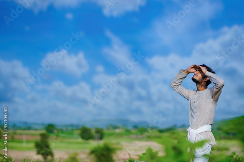 Indian farmer looking at the sky
