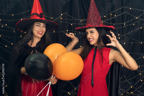 fun two young women wear red dress witch Halloween