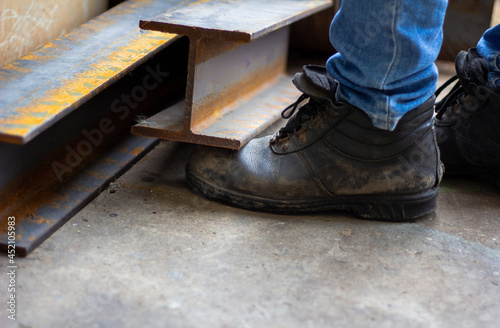 Wear safety shoes to ensure safety at work. construction workers wear safety shoes. concept.