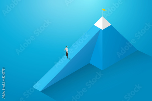 Businessman walked towards his goal on mountain.