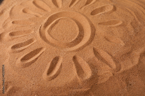 Sun Drawn in the Sand on a Beach