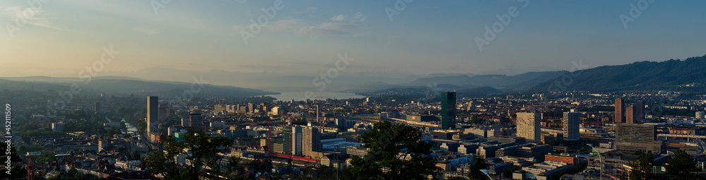 Large panorama of the city of Zurich in the morning with a blue sky from the Waid. 