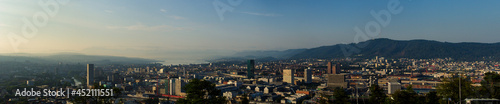 Large panorama of the city of Zurich in the morning with a blue sky from the Waid. With Prime Tower  Uetliberg and Lake Zurich. 
