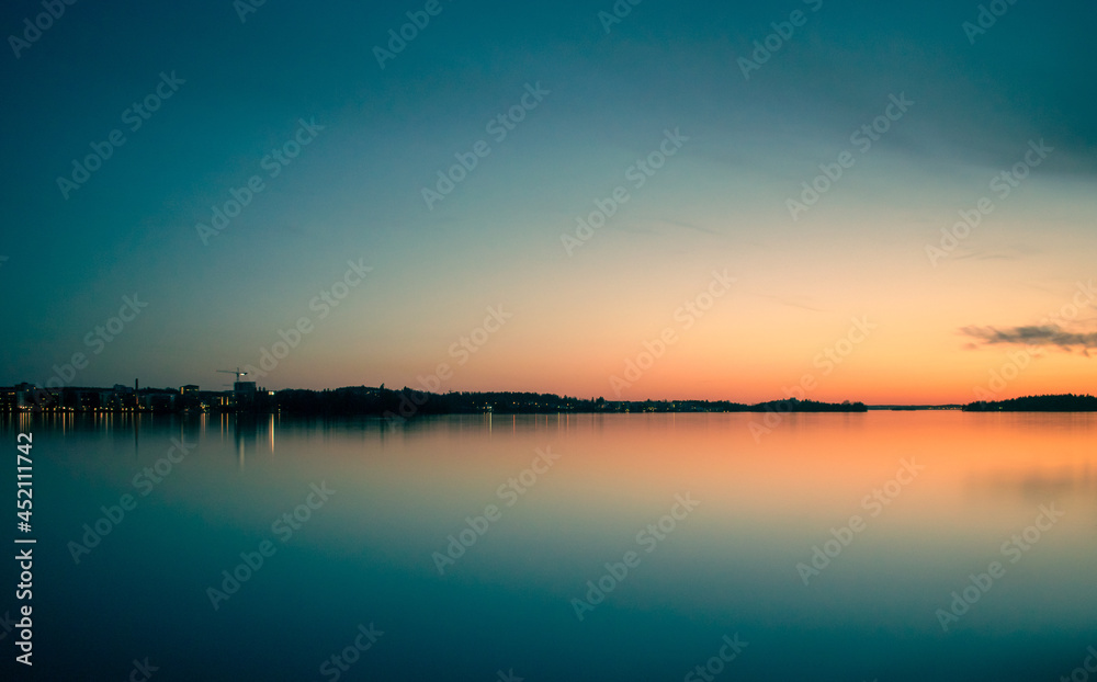 Sunset over the lake with reflections in Finland