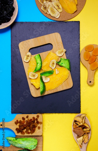 Mixture of dried fruits. Symbols of the Jewish holiday Tu Bishvat. Thanksgiving Day. Flat lay, top view. Vertical phoro photo