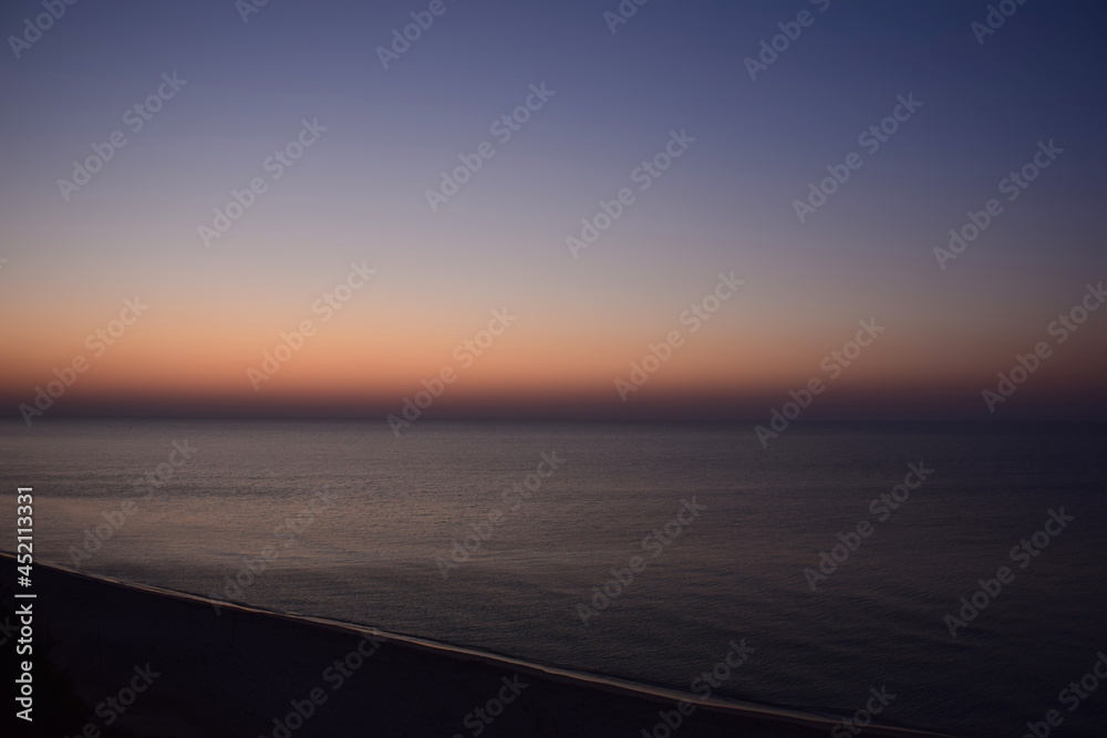 Pre-dawn calm sea photographed from a distance from a high angle