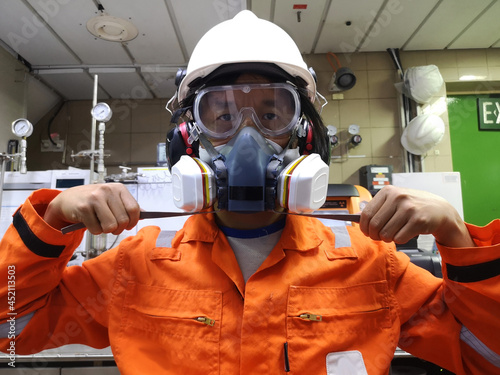 Multi-purpose respirator half mask for toxic gas protection. The man prepare to wear Multi-purpose half mask. photo